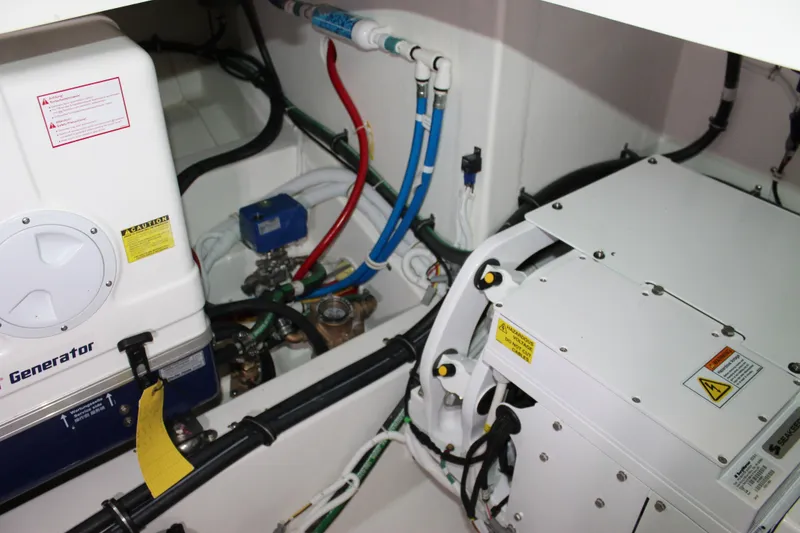 Slide: The Image of Engine room of 2022 Tiara Yachts 43 LS, showcasing generator and wiring. - 73