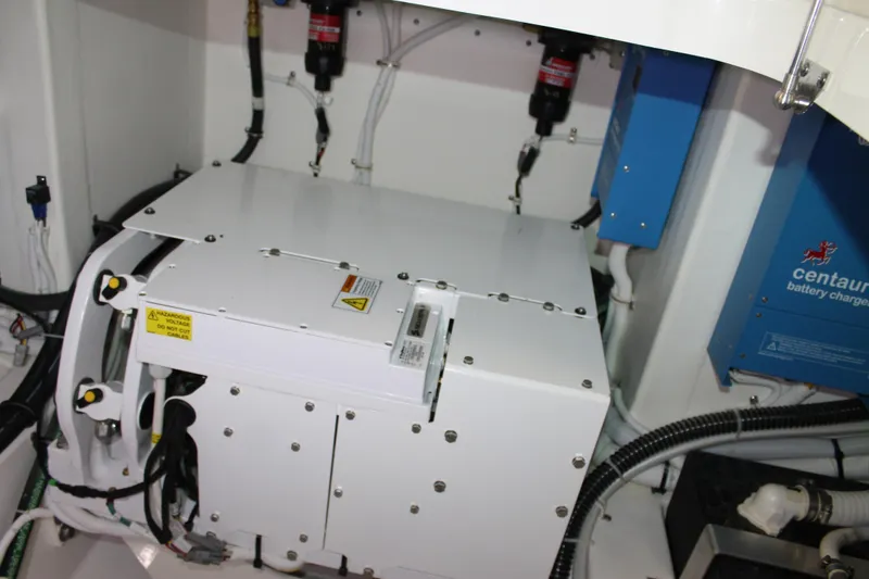 Slide: The Image of Engine room of 2022 Tiara Yachts 43 LS, featuring battery charger and equipment. - 74