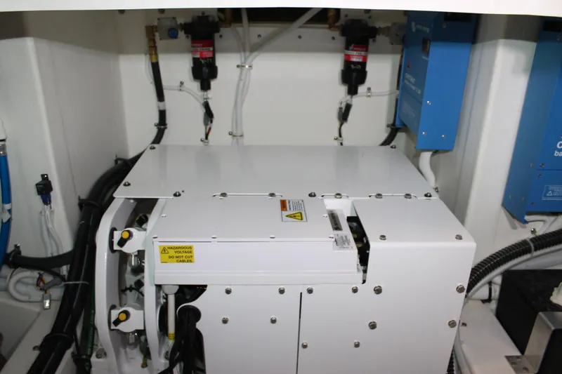 Slide: The Image of Engine room of 2022 Tiara Yachts 43 LS, showcasing electrical components and wiring. - 75