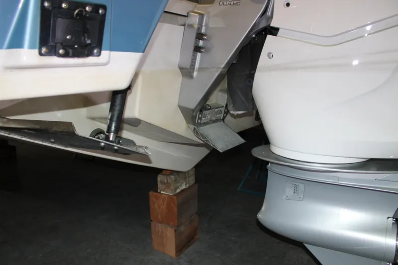 Slide: The Image of 2022 Tiara Yachts 43 LS boat engine and propeller detail on wooden blocks. - 77