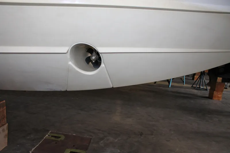 Slide: The Image of 2022 Tiara Yachts 43 LS hull with visible thruster in a storage area. - 79