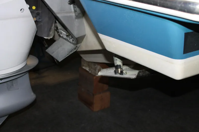 Slide: The Image of 2022 Tiara Yachts 43 LS boat hull and motor detail in a workshop. - 80