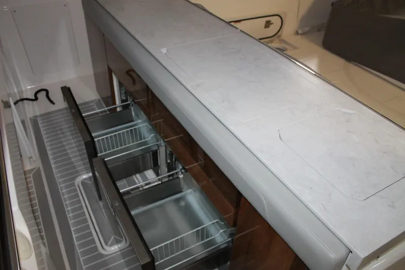 Slide: The Image of 2022 Tiara Yachts 43 LS interior with sleek storage drawers and modern design. - 9