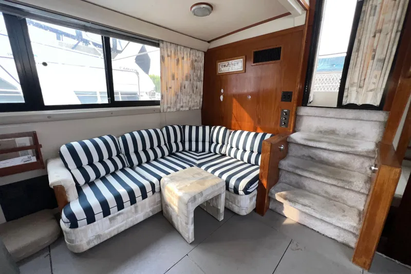Slide: The Image of Interior of 1988 Carver 3807 Aft Cabin Motor Yacht with striped seating and stairs. - 12