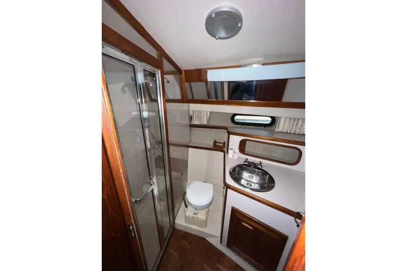 Slide: The Image of 1988 Carver 3807 Aft Cabin Motor Yacht bathroom with shower, sink, and toilet. - 17