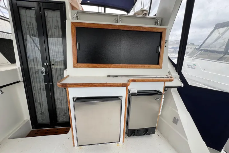 Slide: The Image of 1988 Carver 3807 Aft Cabin Motor Yacht interior with kitchenette and appliances. - 22