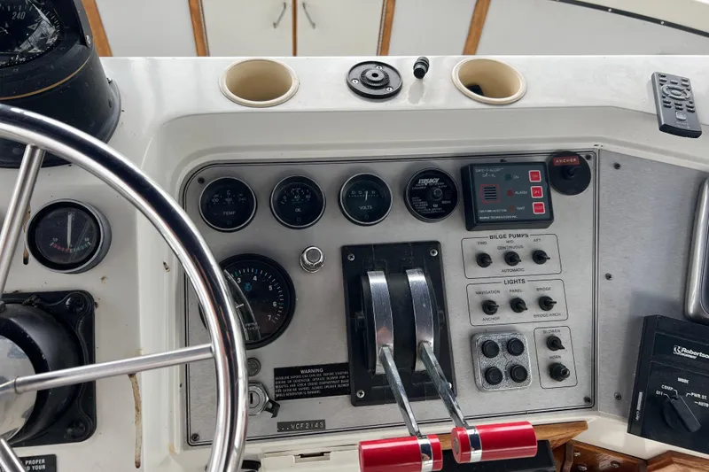 Slide: The Image of Control panel of 1988 Carver 3807 Aft Cabin Motor Yacht with gauges and switches. - 25