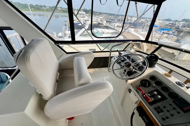 Slide: The Image of Interior helm of 1988 Carver 3807 Aft Cabin Motor Yacht with steering wheel and controls. - 4