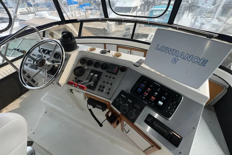 Slide: The Image of Helm of 1988 Carver 3807 Aft Cabin Motor Yacht with navigation equipment and steering wheel. - 5