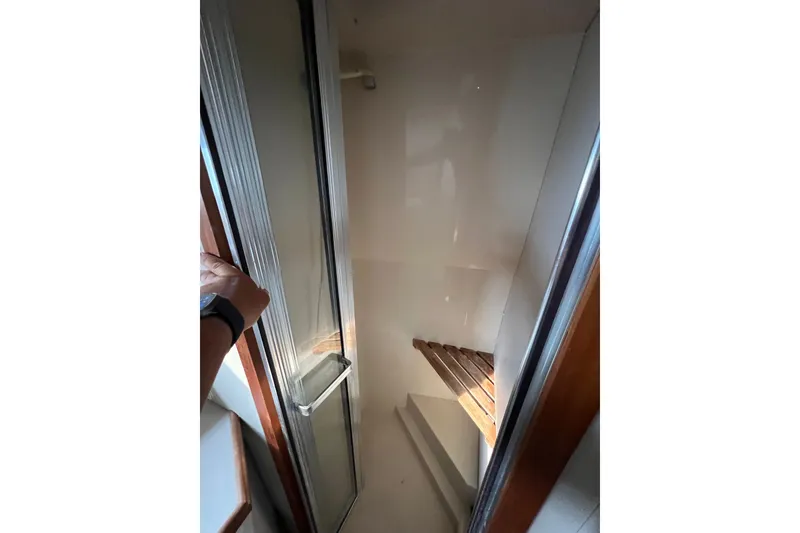 Slide: The Image of Shower area in 1988 Carver 3807 Aft Cabin Motor Yacht, featuring glass door and wooden accents. - 8
