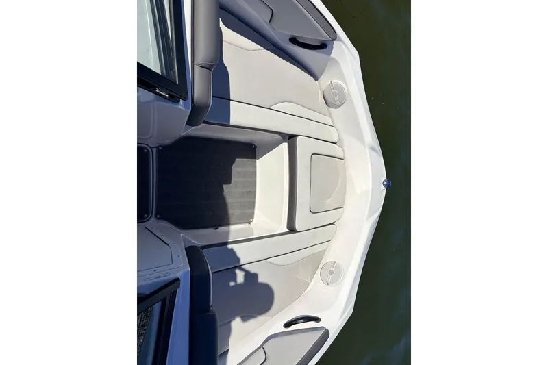 Slide: The Image of 2024 Yamaha Boats AR190 bow seating area with cushioned seats and cup holders. - 10