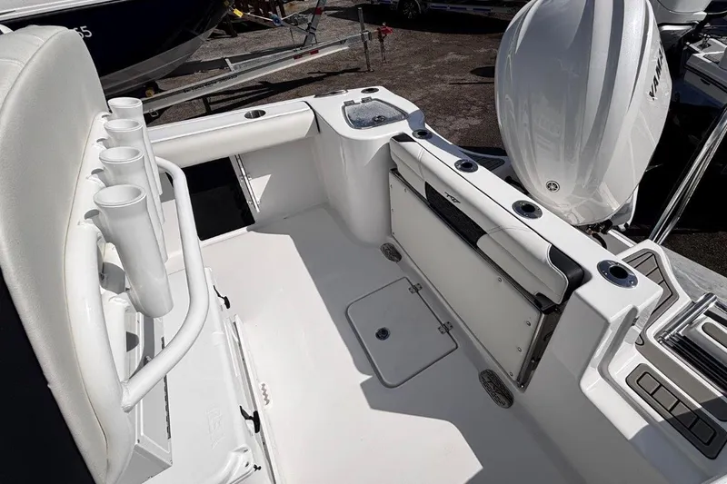 Slide: The Image of 2026 Tidewater 232 CC Adventure boat interior with rod holders and seating. - 10