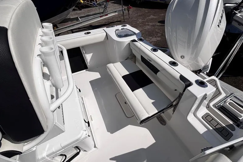 Slide: The Image of 2026 Tidewater 232 CC Adventure boat interior with seating and rod holders. - 11