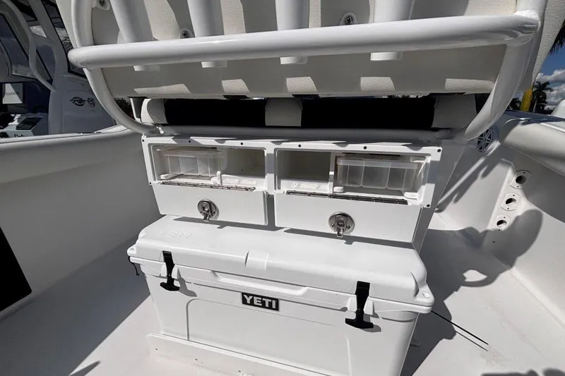 Slide: The Image of 2026 Tidewater 232 CC Adventure boat interior with storage compartments and Yeti cooler. - 14