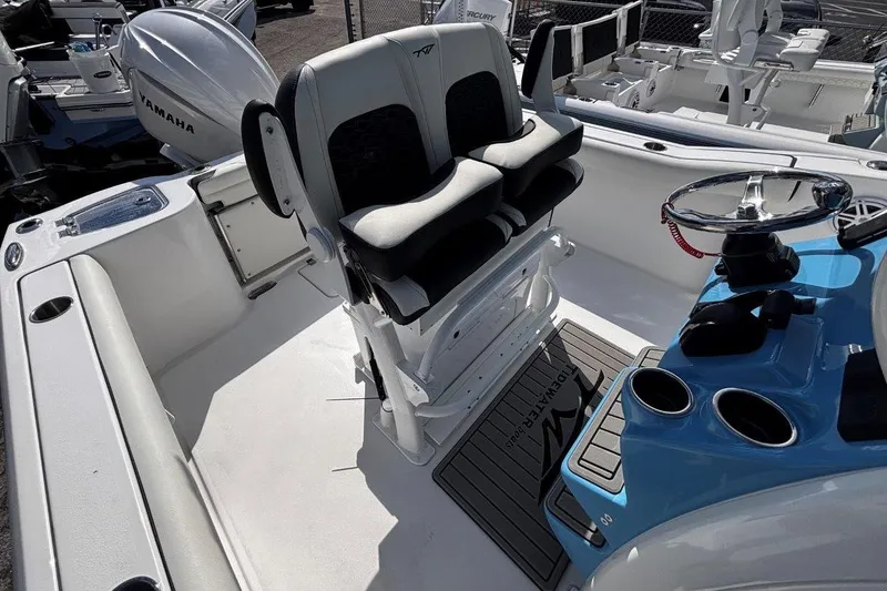 Slide: The Image of 2026 Tidewater 232 CC Adventure boat interior with dual seats and steering console. - 16