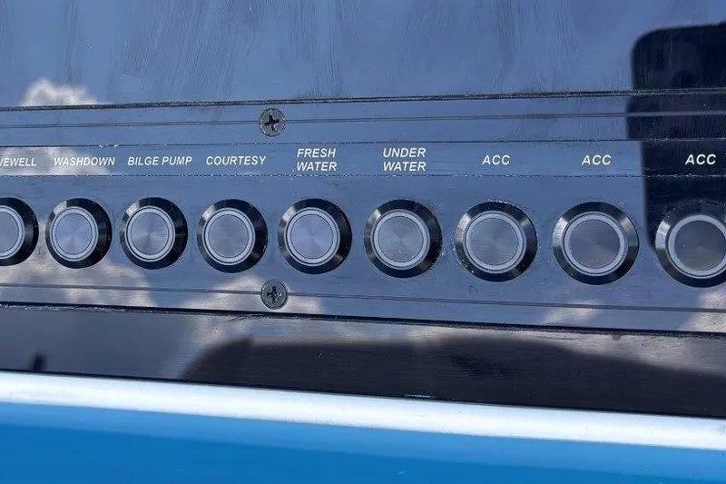 Slide: The Image of Control panel of 2026 Tidewater 232 CC Adventure boat with labeled buttons. - 18