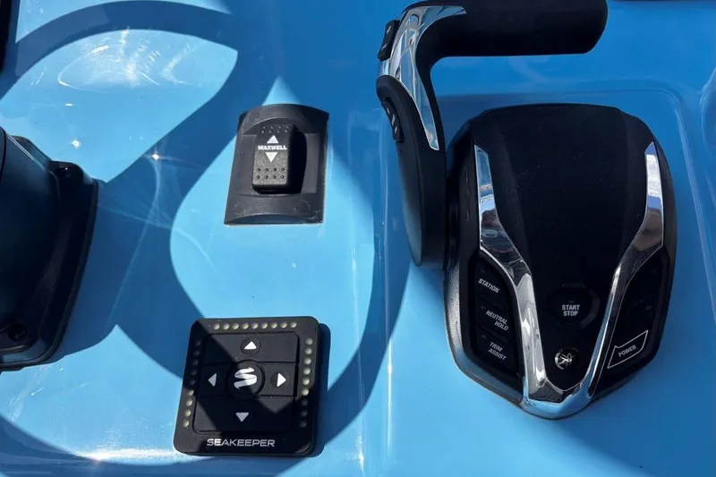 Slide: The Image of Control panel of 2026 Tidewater 232 CC Adventure boat with throttle and Seakeeper system. - 19