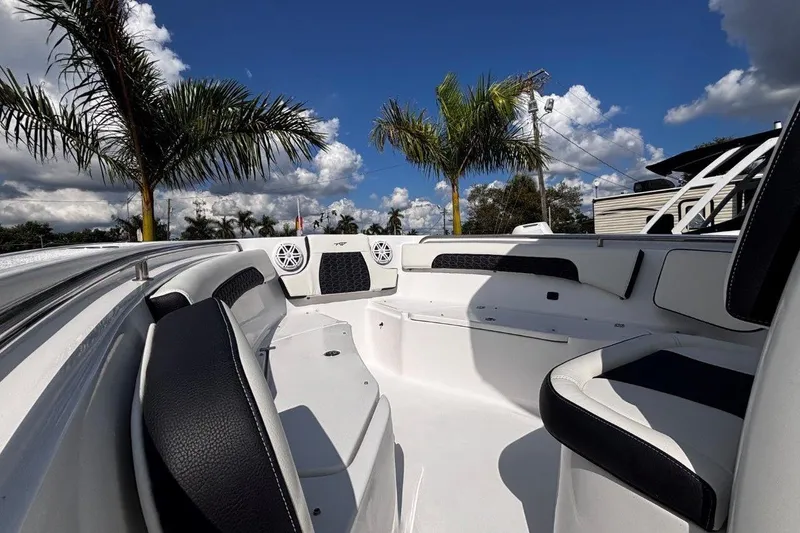 Slide: The Image of 2026 Tidewater 232 CC Adventure boat interior with palm trees and blue sky background. - 22
