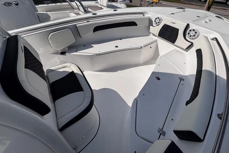 Slide: The Image of 2026 Tidewater 232 CC Adventure boat interior with cushioned seating and modern design. - 23