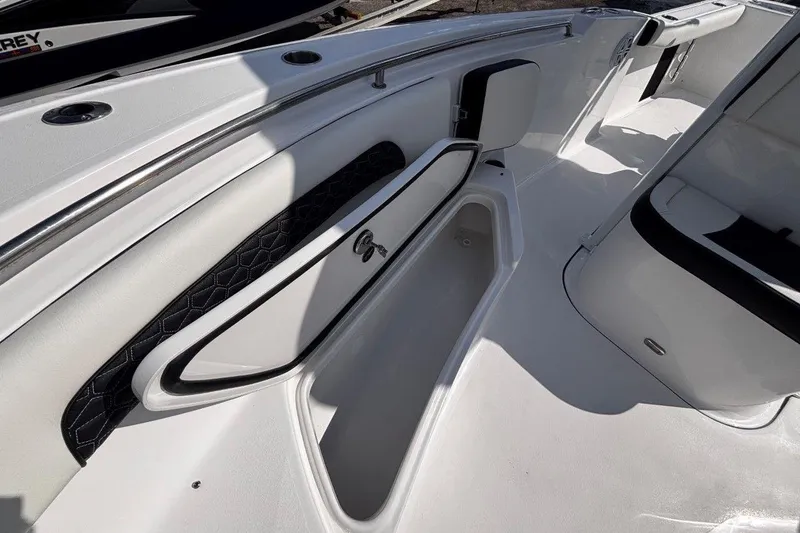 Slide: The Image of 2026 Tidewater 232 CC Adventure boat interior with open storage compartment. - 26