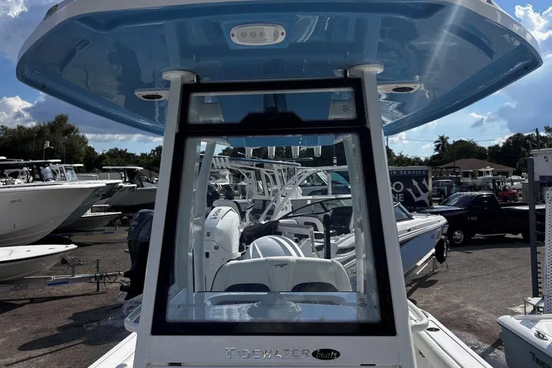 Slide: The Image of 2026 Tidewater 232 CC Adventure boat at a marina, showcasing sleek design and modern features. - 28