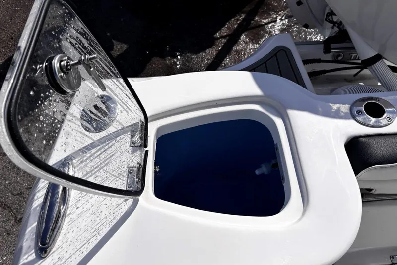 Slide: The Image of Open hatch on 2026 Tidewater 232 CC Adventure boat, showing interior compartment. - 29