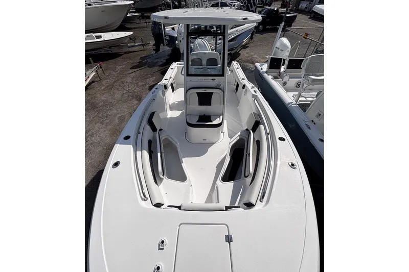 Slide: The Image of 2026 Tidewater 232 CC Adventure boat, spacious deck, sleek design, parked in marina. - 31