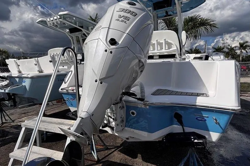Slide: The Image of 2026 Tidewater 232 CC Adventure boat with powerful 300 V6 engine, docked under cloudy skies. - 7