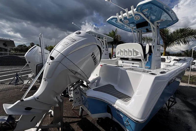 Slide: The Image of 2026 Tidewater 232 CC Adventure boat with Yamaha engine, parked outdoors under cloudy sky. - 8