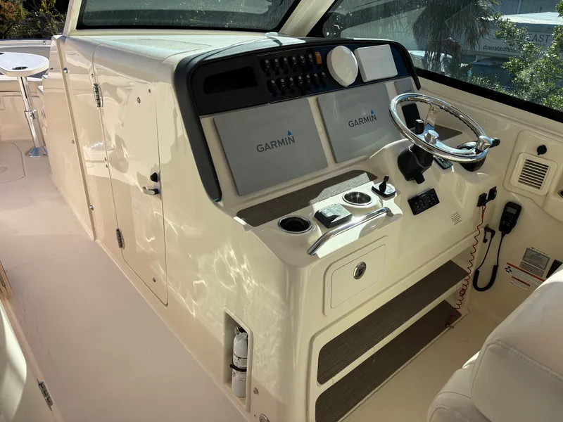 Slide: The Image of 2019 Grady-White Freedom 375 boat helm with Garmin navigation system and steering wheel. - 13