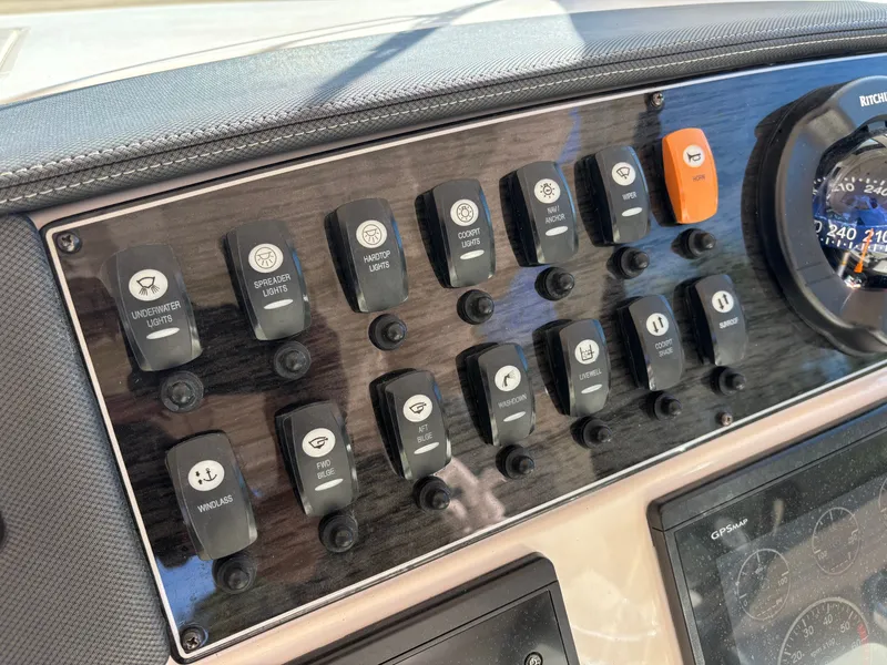 Slide: The Image of Control panel of 2019 Grady-White Freedom 375 boat with various switches and gauges. - 17
