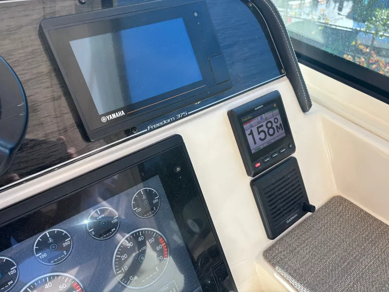 Slide: The Image of Control panel of 2019 Grady-White Freedom 375 boat with Yamaha and Garmin displays. - 18