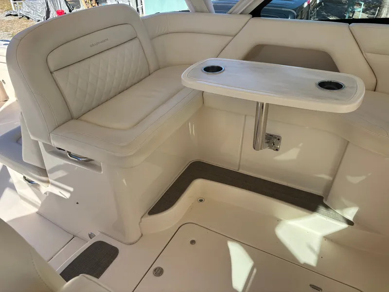 Slide: The Image of 2019 Grady-White Freedom 375 boat interior with cushioned seating and table. - 23
