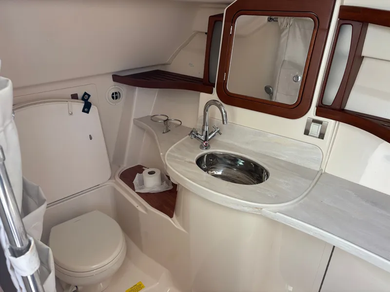 Slide: The Image of 2019 Grady-White Freedom 375 boat bathroom with sink, toilet, and wooden accents. - 29