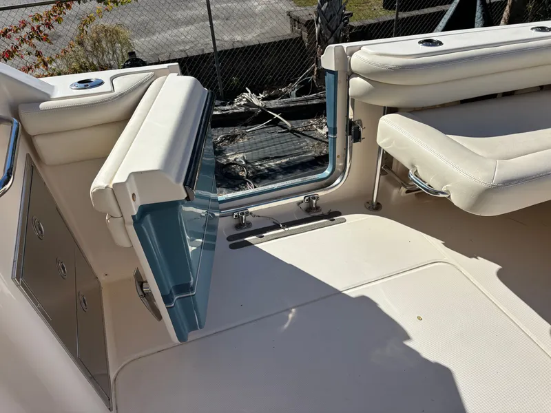 Slide: The Image of 2019 Grady-White Freedom 375 boat interior with open door and seating area. - 35