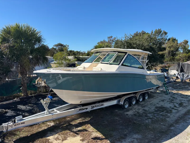 Slide: The Image of 2019 Grady-White Freedom 375 boat on trailer, parked outdoors under clear blue sky. - 39