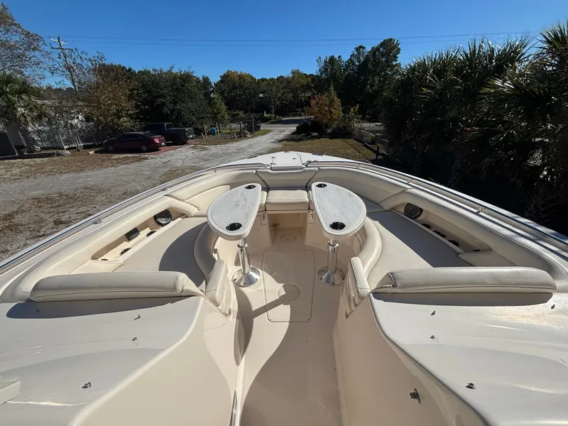 Slide: The Image of 2019 Grady-White Freedom 375 boat interior with seating and tables, parked outdoors. - 4
