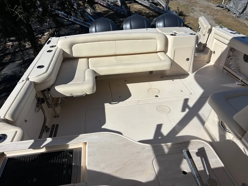 Slide: The Image of 2019 Grady-White Freedom 375 boat interior with beige seating and cup holders. - 9