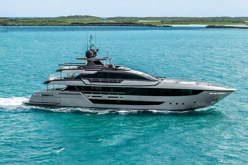 The Image of Luxury 2025 Riva 130' Bellissima yacht cruising in turquoise waters near modern buildings. - 0