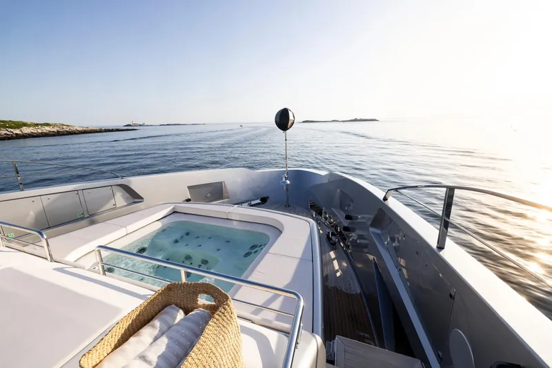 Slide: The Image of Luxury yacht Riva 130' Bellissima 2025 on serene blue waters, rear view. - 14