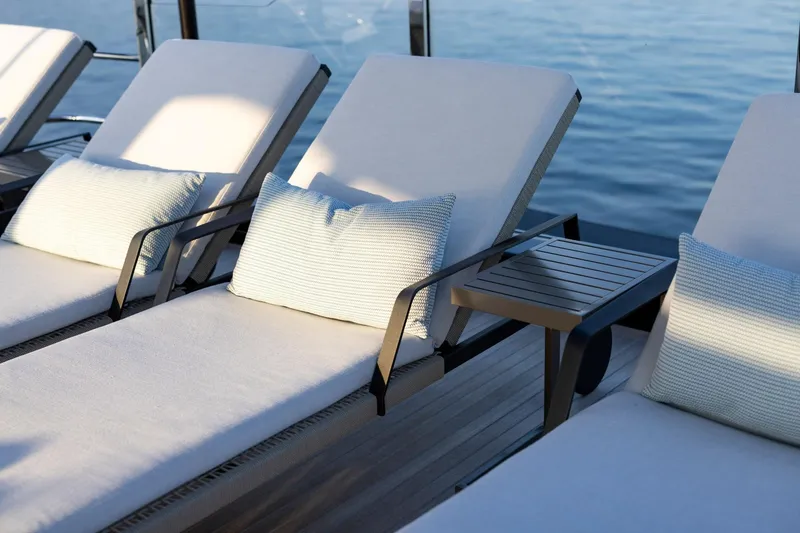 Slide: The Image of Aerial view of 2025 Riva 130' Bellissima yacht cruising in clear green waters. - 17