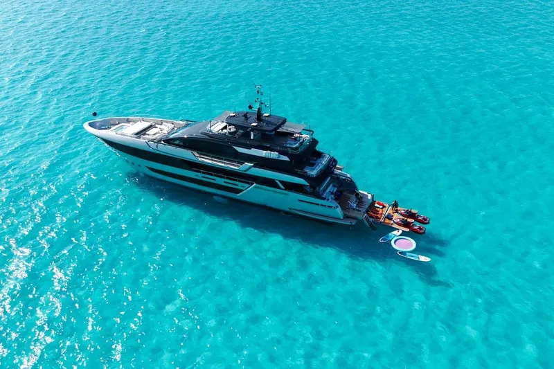 Slide: The Image of Luxury 2025 Riva 130' Bellissima yacht cruising on clear blue waters. - 2