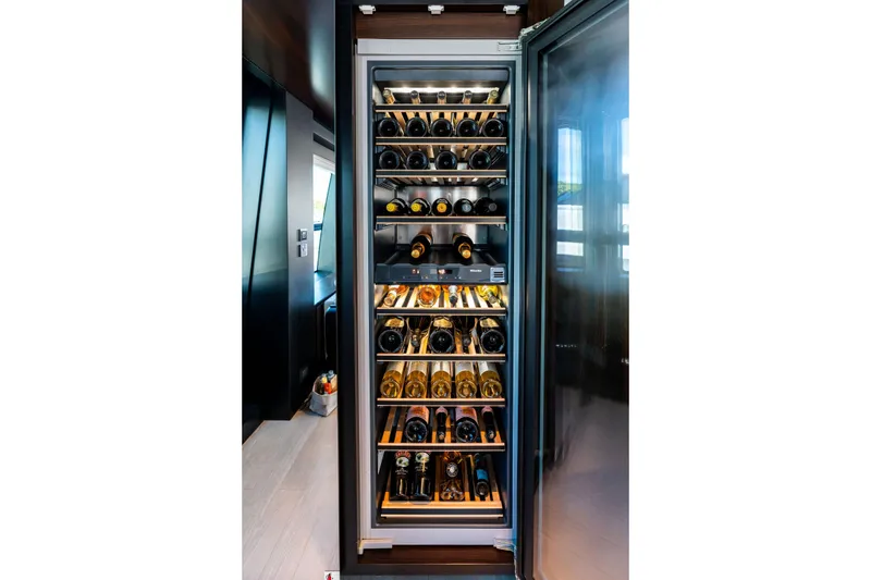 Slide: The Image of Luxurious wine fridge on Riva 130' Bellissima yacht, 2025 model, showcasing premium wine collection. - 51