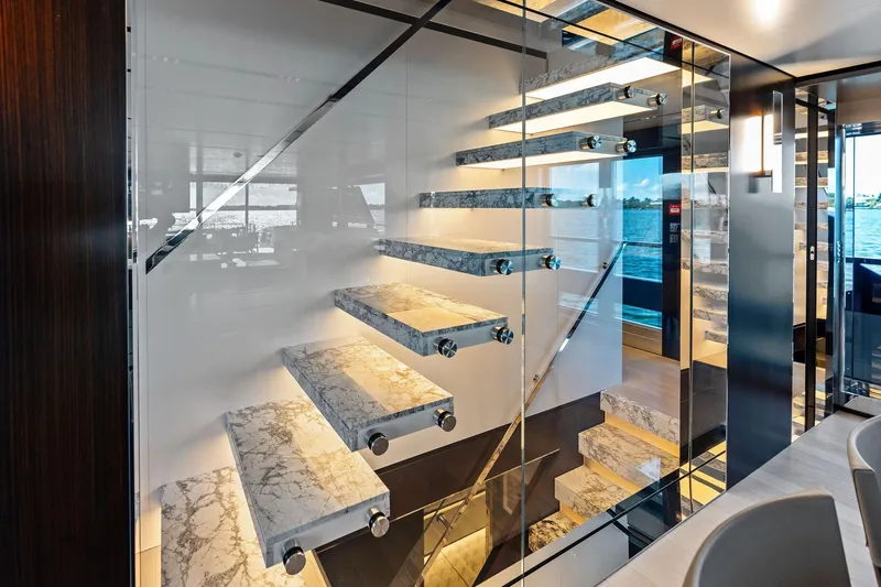 Slide: The Image of Luxurious interior staircase of 2025 Riva 130' Bellissima yacht with marble steps and glass railing. - 61