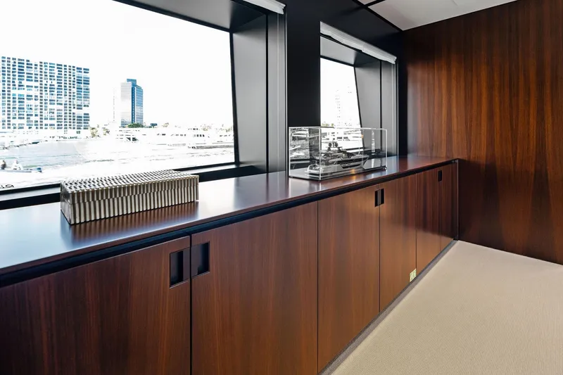 Slide: The Image of Luxurious interior of 2025 Riva 130' Bellissima yacht with sleek wood paneling and large windows. - 67