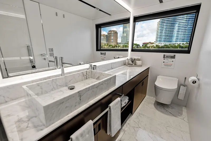 Slide: The Image of Luxurious bathroom on 2025 Riva 130' Bellissima yacht with marble sink and city view. - 74