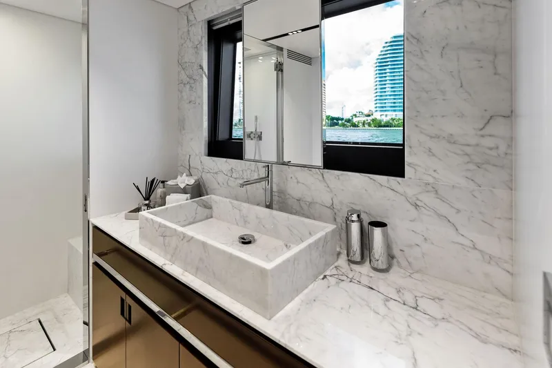 Slide: The Image of Luxurious marble bathroom on 2025 Riva 130' Bellissima yacht with modern fixtures and scenic window view. - 77