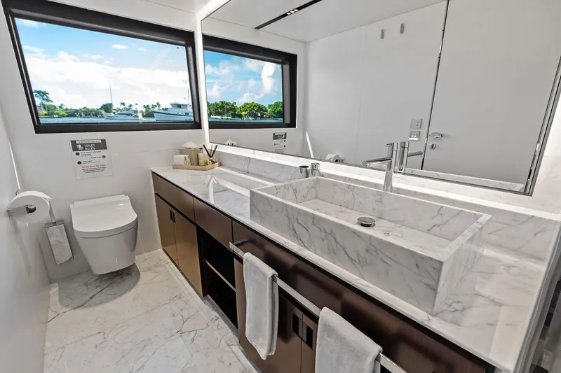 Slide: The Image of Luxurious bathroom in 2025 Riva 130' Bellissima yacht with marble sink and scenic window view. - 81