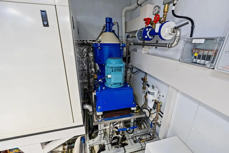Slide: The Image of Engine room machinery of 2025 Riva 130' Bellissima yacht, featuring blue mechanical components. - 98