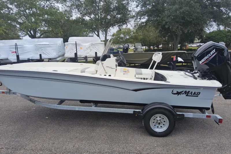 The Image of 2026 Mako Pro Skiff 17 CC boat on trailer, featuring Mercury outboard motor. - 0